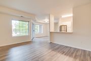 Fargo apartment for rent - A spacious room with wooden floors and a kitchenette.