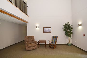 Zimmerman apartment for rent - a living room with two chairs and a table and a potted plant