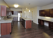 West Fargo apartment for rent - A kitchen with dark wood floors and a marble countertop.