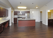 West Fargo apartment for rent - A kitchen with dark wood floors and white walls.