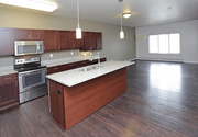 West Fargo apartment for rent - A kitchen with wooden cabinets and a stainless steel oven.