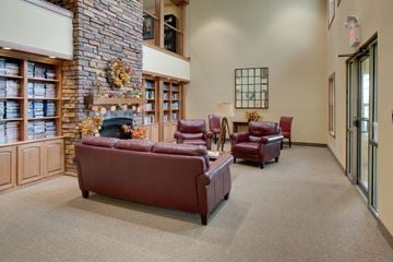 Fergus Falls apartment for rent - a living room with couches and chairs and a fireplace