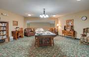 St Cloud apartment for rent - A room with a carpeted floor and a large table surrounded by chairs at Savanna Apartments, St Cloud, Minnesota