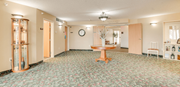 St Cloud apartment for rent - A room with a round mirror on the wall and a table in the middle at Savanna  Apartments, St Cloud, MN
