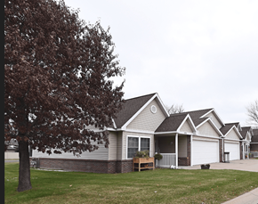 Sartell townhouse for rent - a house with a tree in front of it