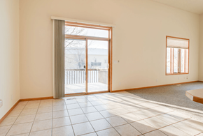 Fargo townhouse for rent - A room with a sliding glass door and a small window.