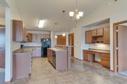 Fargo apartment for rent - a kitchen with wooden cabinets and stainless steel appliances at Urban View Apartments, Fargo, ND