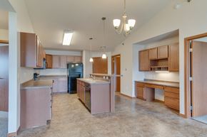 Fargo apartment for rent - a kitchen with wooden cabinets and stainless steel appliances at Urban View Apartments, Fargo, ND