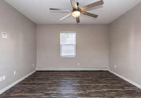 Fargo apartment for rent - A room with a ceiling fan and wooden flooring. at Warehouse Apartments, Fargo