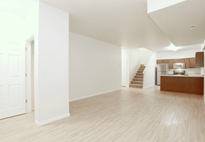 Dilworth townhouse for rent - A spacious room with wooden floors and white walls.