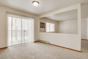 Fargo apartment for rent - A room with a window covered by white blinds and a carpet on the floor.