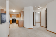 Fargo apartment for rent - A kitchen area with a refrigerator, oven, and cabinets.