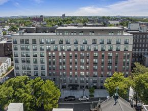 Jersey City apartment for rent - an aerial view of a large building with trees in front of it