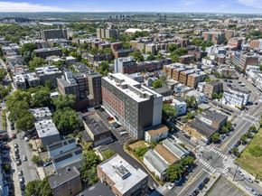 Jersey City apartment for rent - an aerial view of a city with buildings and cars