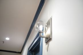 Hoboken apartment for rent - A wall light is mounted on a white wall.