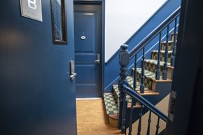Hoboken apartment for rent - A staircase with a blue door and a sign that says B stair.