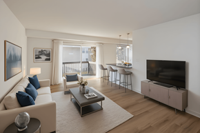 Feasterville apartment for rent - A living room with a white couch, a coffee table, and a television.