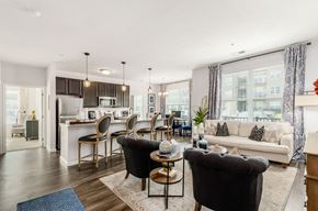 Columbus apartment for rent - A modern living room with a kitchen in the background.