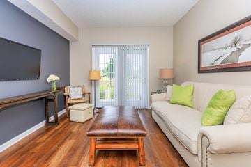 Lewis Center apartment for rent - A living room with a white couch and a wooden coffee table.
