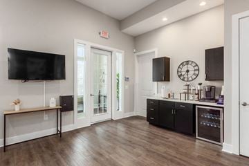 Hilliard apartment for rent - A kitchen with black cabinets and a wooden floor.