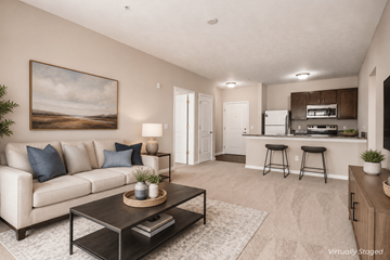 Worthington apartment for rent - A living room with a beige couch, a coffee table, and a painting on the wall.