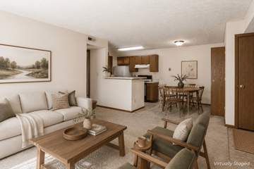 Powell apartment for rent - A living room with a couch, coffee table, and a painting on the wall.