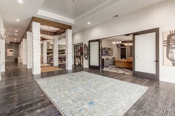 Upper Arlington apartment for rent - a living room with a large rug and a white door