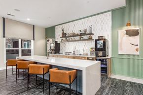 Upper Arlington apartment for rent - A bar area with a white counter and orange chairs.
