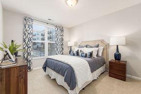 Upper Arlington apartment for rent - A bedroom with a bed, nightstands, and a window with curtains.