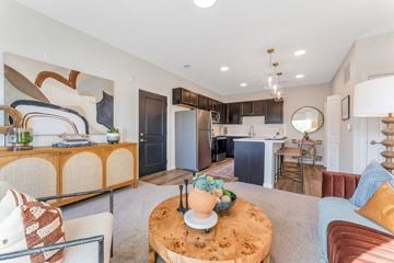 Sunbury apartment for rent - a living room with a couch and a table in front of a kitchen