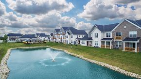 Hilliard apartment for rent - a fountain in the middle of a pond in front of houses
