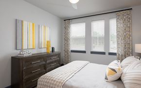 Newberry apartment for rent - A bedroom with a bed, dresser, and two wall art pieces.
