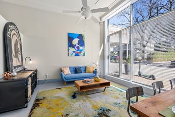 San Antonio apartment for rent - A living room with a blue couch and a painting on the wall.