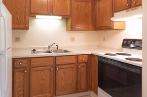 Cedar Grove apartment for rent - a kitchen with wooden cabinets and a stove and a sink