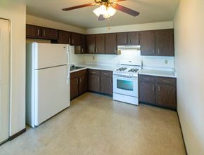 Grafton apartment for rent - A kitchen with a white refrigerator and a white stove top oven.