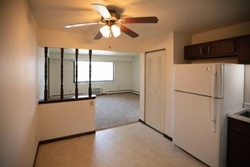 Grafton apartment for rent - A white refrigerator sits in a kitchen next to a window.