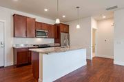 Cedarburg apartment for rent - A kitchen with brown cabinets and a white island.