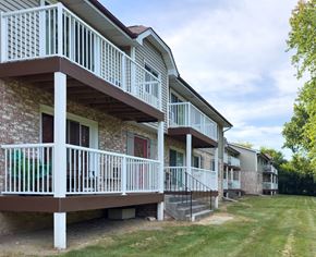 Saukville apartment for rent - Apartment complex with white railings and brown roofs.