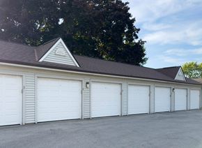 Saukville apartment for rent - A long row of white garage doors are closed.