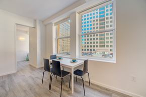 Cleveland apartment for rent - a dining room with large windows and a table and chairs