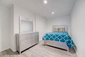 Cleveland apartment for rent - a bedroom with a bed and a dresser with a mirror