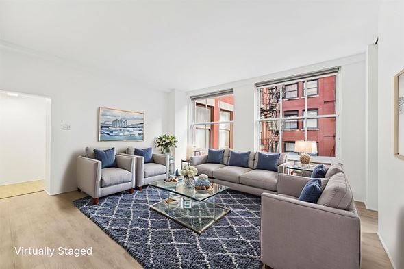 Cleveland apartment for rent - Living room with gray upholstered furniture and blue pillows at Lofts at 629 Apartments, Ohio, 44114