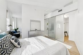 Cleveland apartment for rent - Bedroom with sliding closet doors and wood flooring at Lofts at 629 Apartments, Cleveland, Ohio