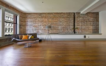 Seattle apartment for rent - an exposed brick wall in a living room with a couch and a chair