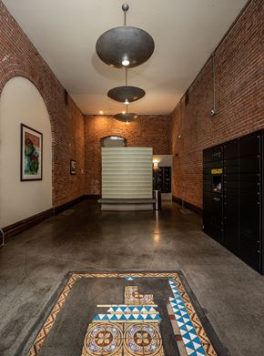 Seattle apartment for rent - a large room with brick walls and a large rug on the floor