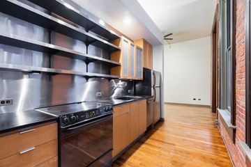 Seattle apartment for rent - A modern kitchen with wooden cabinets and stainless steel appliances.