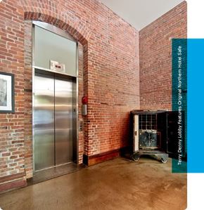Seattle apartment for rent - a brick room with a fireplace and a steel door