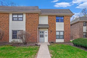 Chicago apartment for rent - A brick building with a white door and windows.
