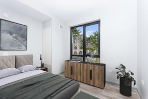 Chicago apartment for rent - a bedroom with a bed and a large window