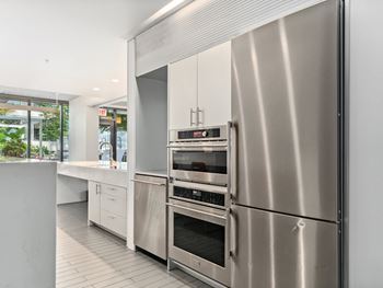 A kitchen with stainless steel appliances and white cabinets
